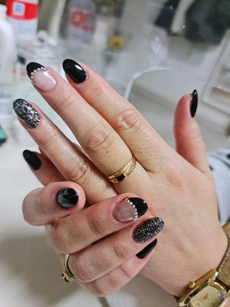 Schwarze Nägel mit Glitzer und Strasssteinen